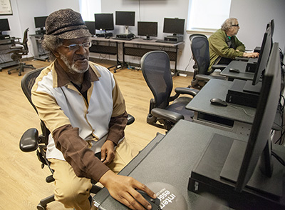Veteran, Dennis Brown, in the computer room at Piquette Square