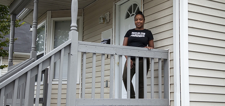 Lachelle in front of her new home.