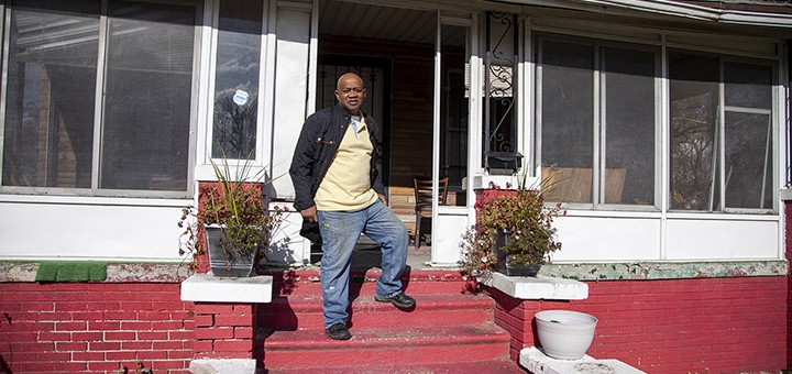Rev. Larry in front of his home