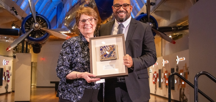 Cathy Liesman receives the Clement Kern Award for Social Impact from Sean  de Four, President and CEO of MiSide